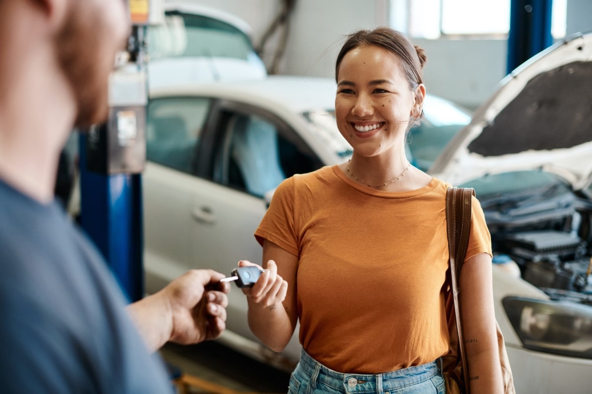 Woman receiving car keys